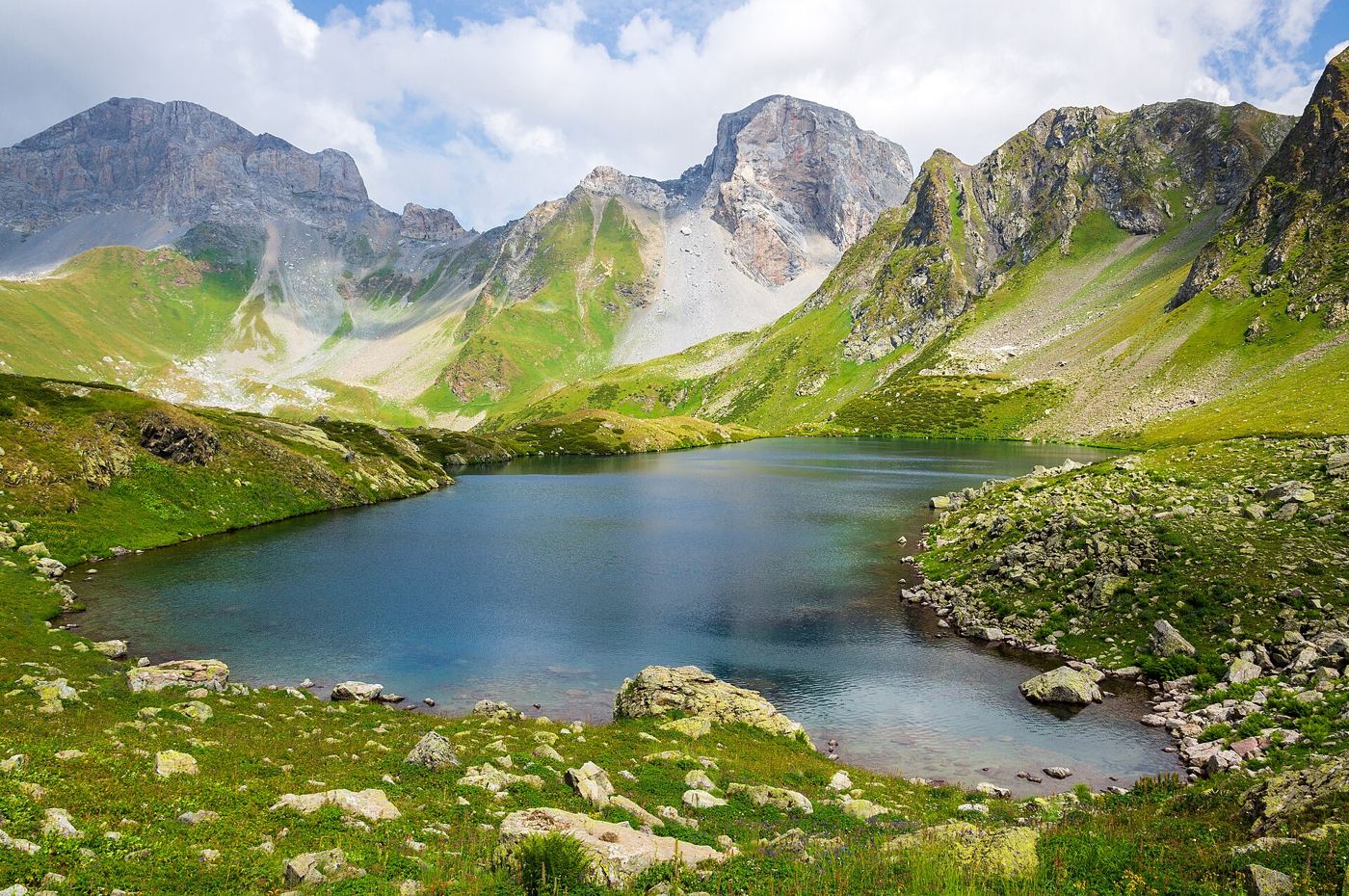 Growing Glacier Lakes Prompt Towns to Plan for Outburst Floods glacial lake in a mountain valley below retreating ice